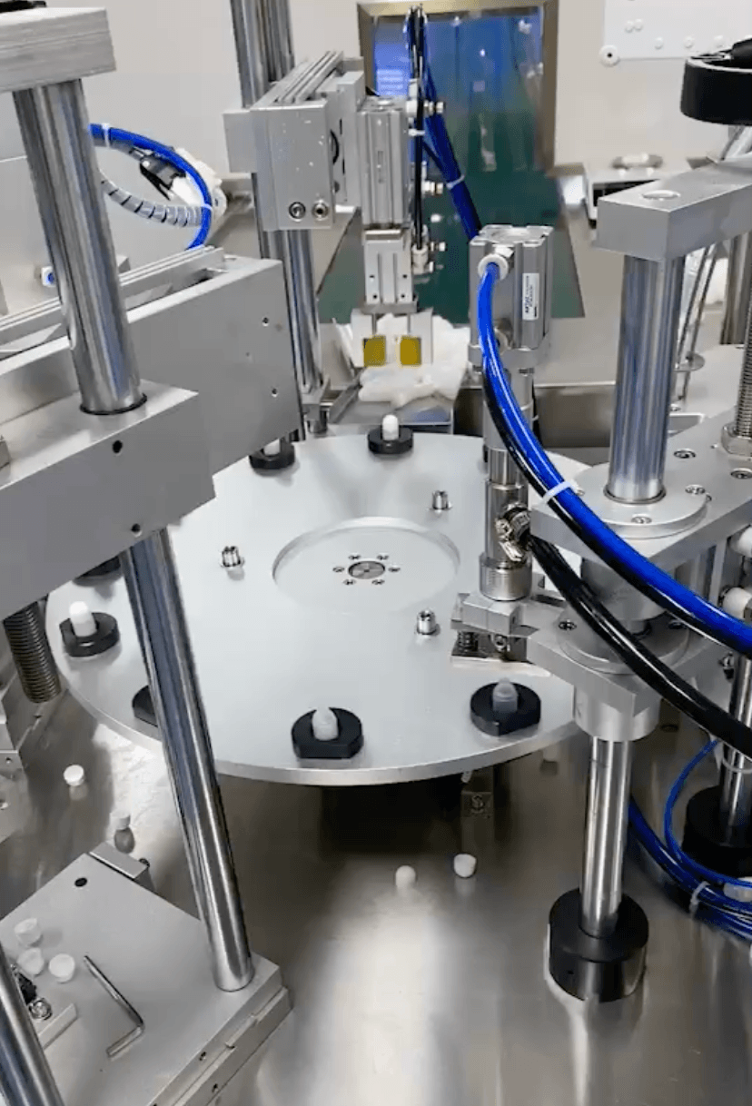 Class 100,000 GMP clean workshop interior – HEPA filtration, stainless steel surfaces, operators in sterile gowns, ensuring contamination-free production.